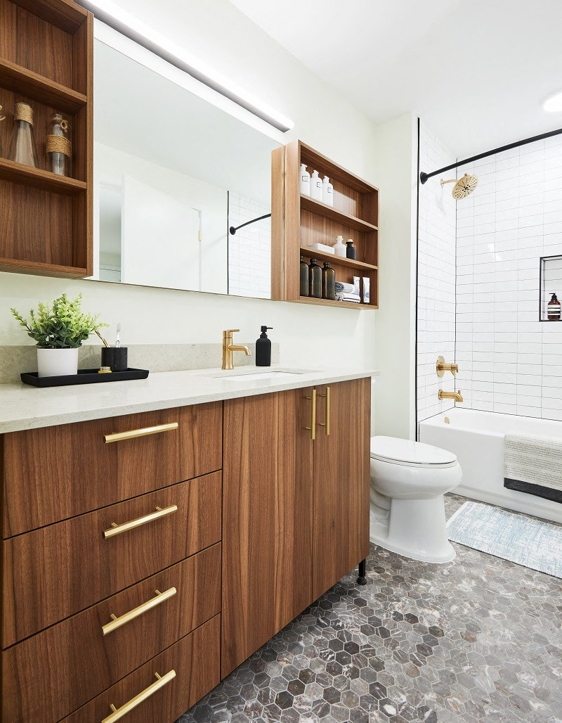 a bathroom with wooden cabinets and a toilet