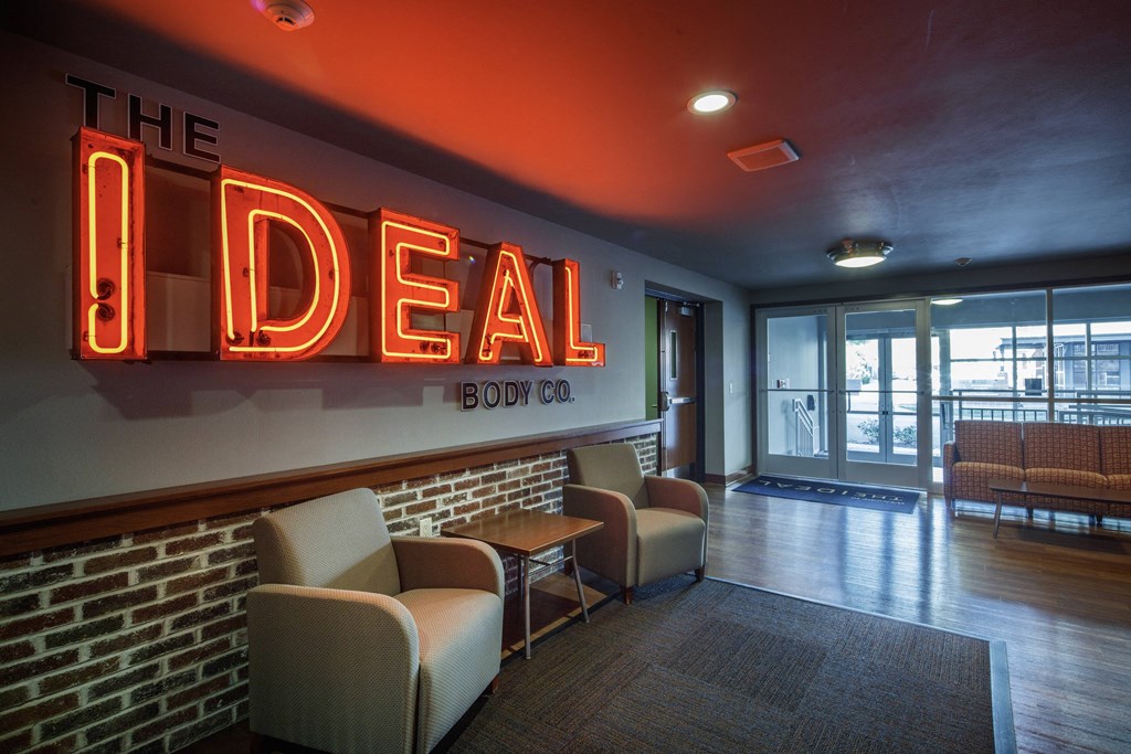 the lobby of the ideal restaurant with chairs and a sign that says the ideal