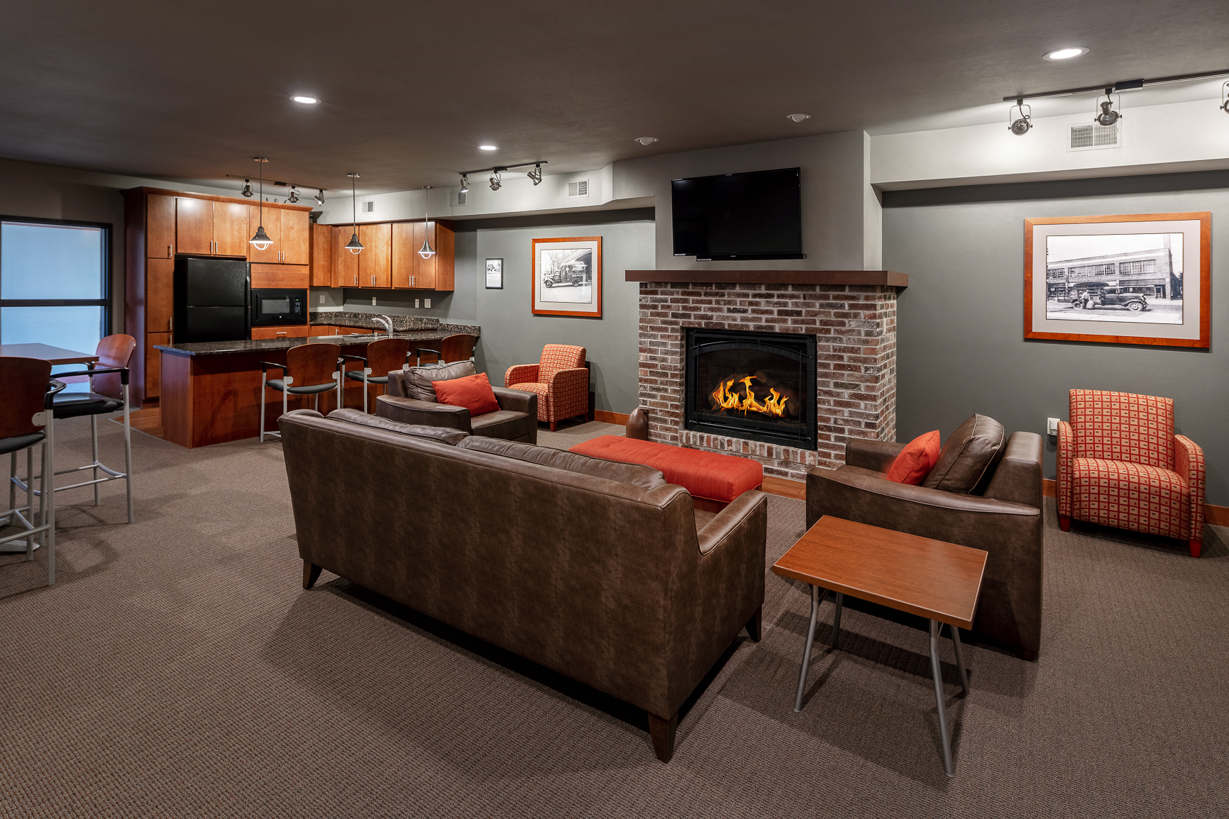 a living room with couches and chairs and a fireplace