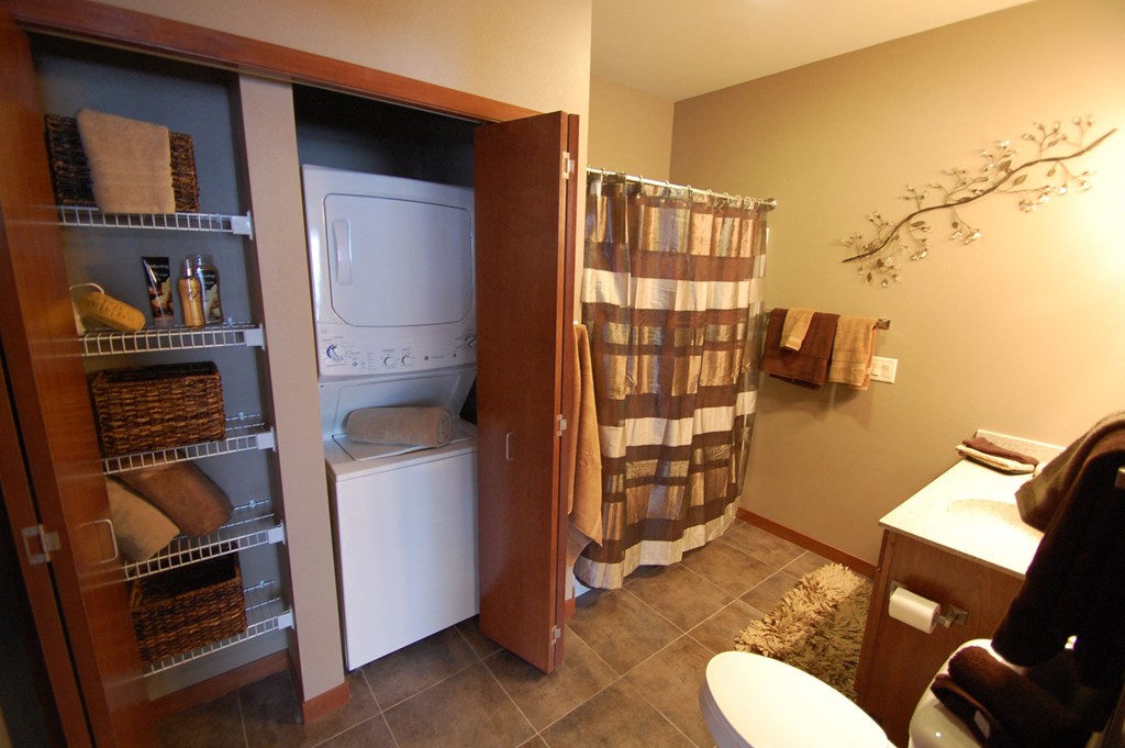 a bathroom with a washer and dryer in a closet