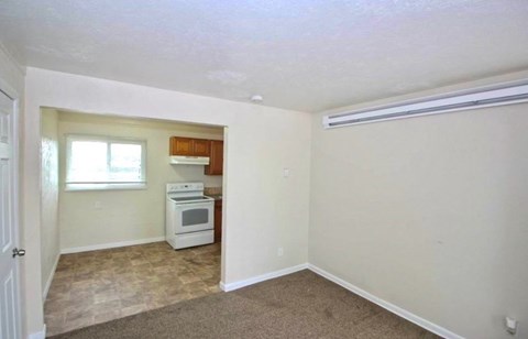 A small room with a white oven and a window.
