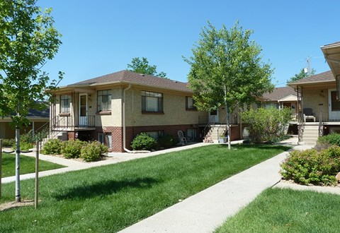 A sunny day at a residential area with houses and green lawns.