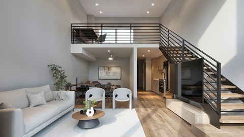 A modern living room with a staircase leading to the upper floor.