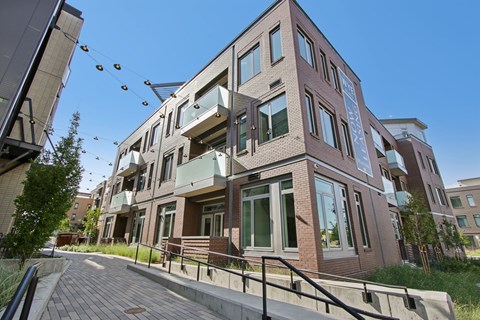 A modern building with a glass entrance and a balcony.