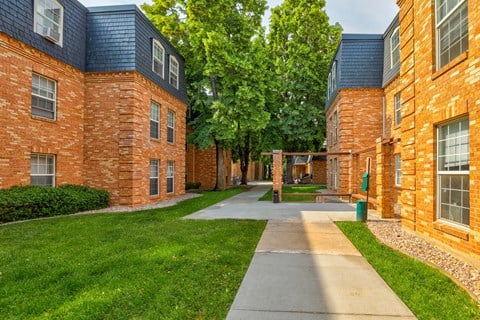 a walkway between two buildings on a sunny day
