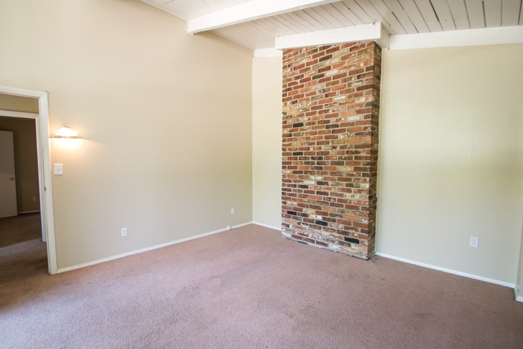 Carpeted Bedroom with Exposed Brick wall