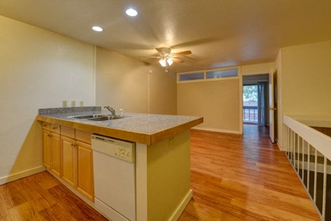 a kitchen with an island and a door to a living room