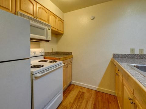 a kitchen with a stove microwave and refrigerator