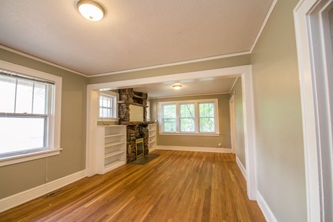 A room with wooden floors and a window.
