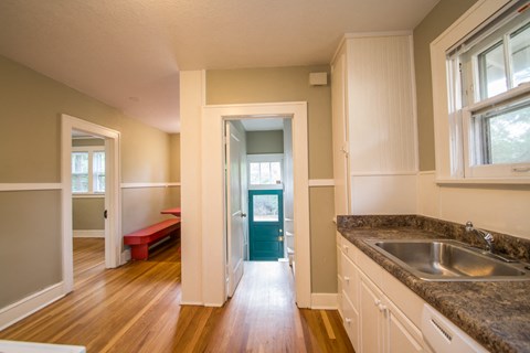A kitchen with a sink and a window.