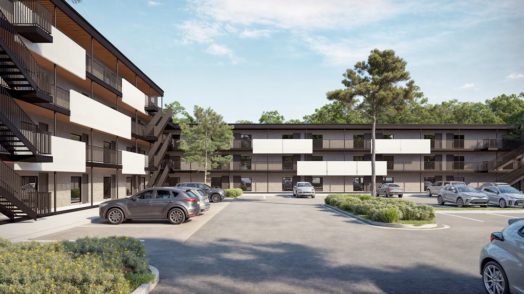 a rendering of an apartment complex with cars parked in a parking lot