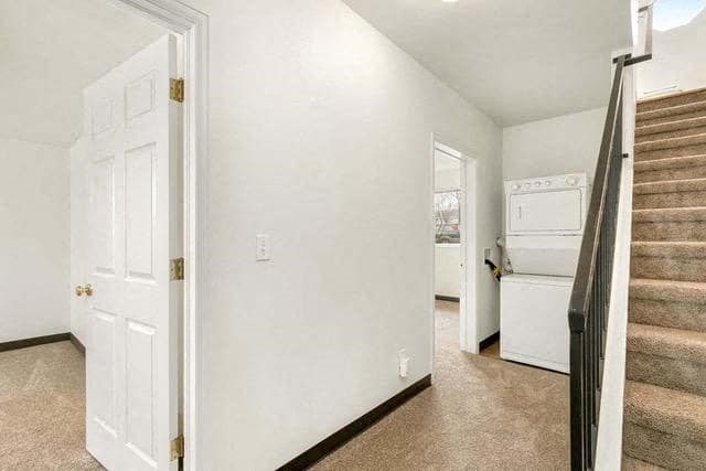 a white room with a staircase and a white door