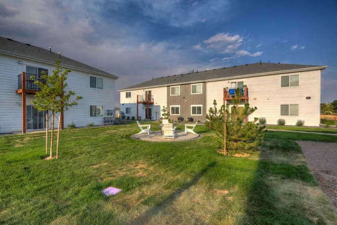 a backyard with a fire pit and seating area