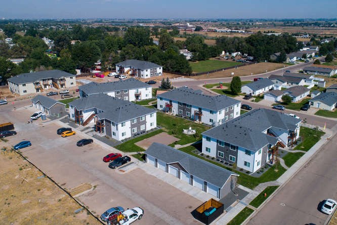 arial view of a housing complex with cars parked on the street