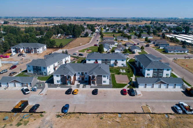 arial view of a neighborhood with houses and cars parked on the street