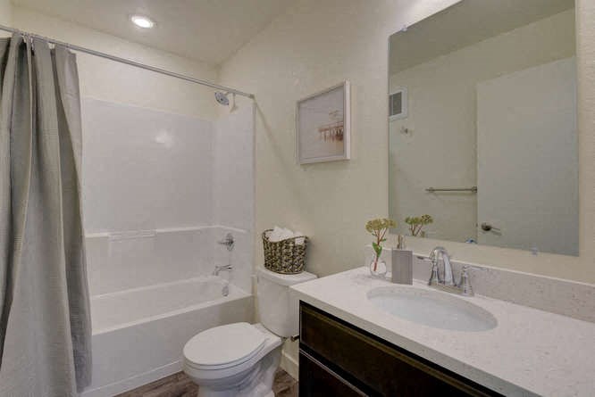 a bathroom with a toilet sink and shower