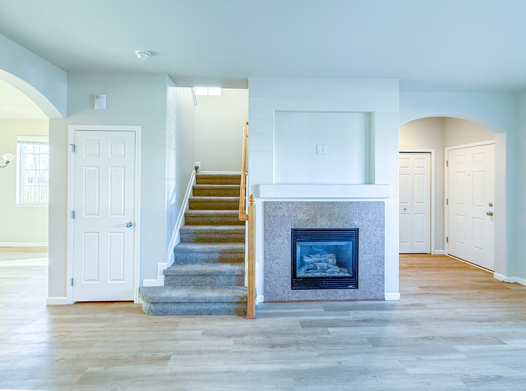 A modern living room with a staircase leading to the upper level.