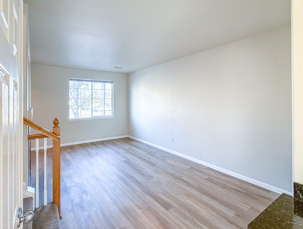 A room with wooden floors and a window.