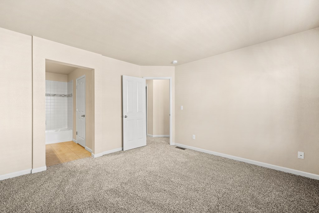 A room with a carpeted floor and white walls.