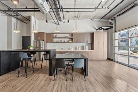 A modern kitchen with a dining table and chairs.