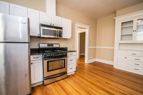 a kitchen with stainless steel appliances and white cabinets