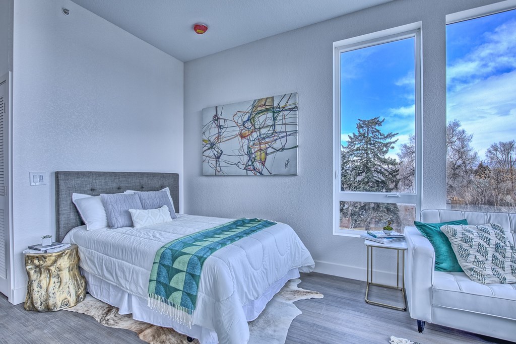 A bedroom with a large bed and a couch.