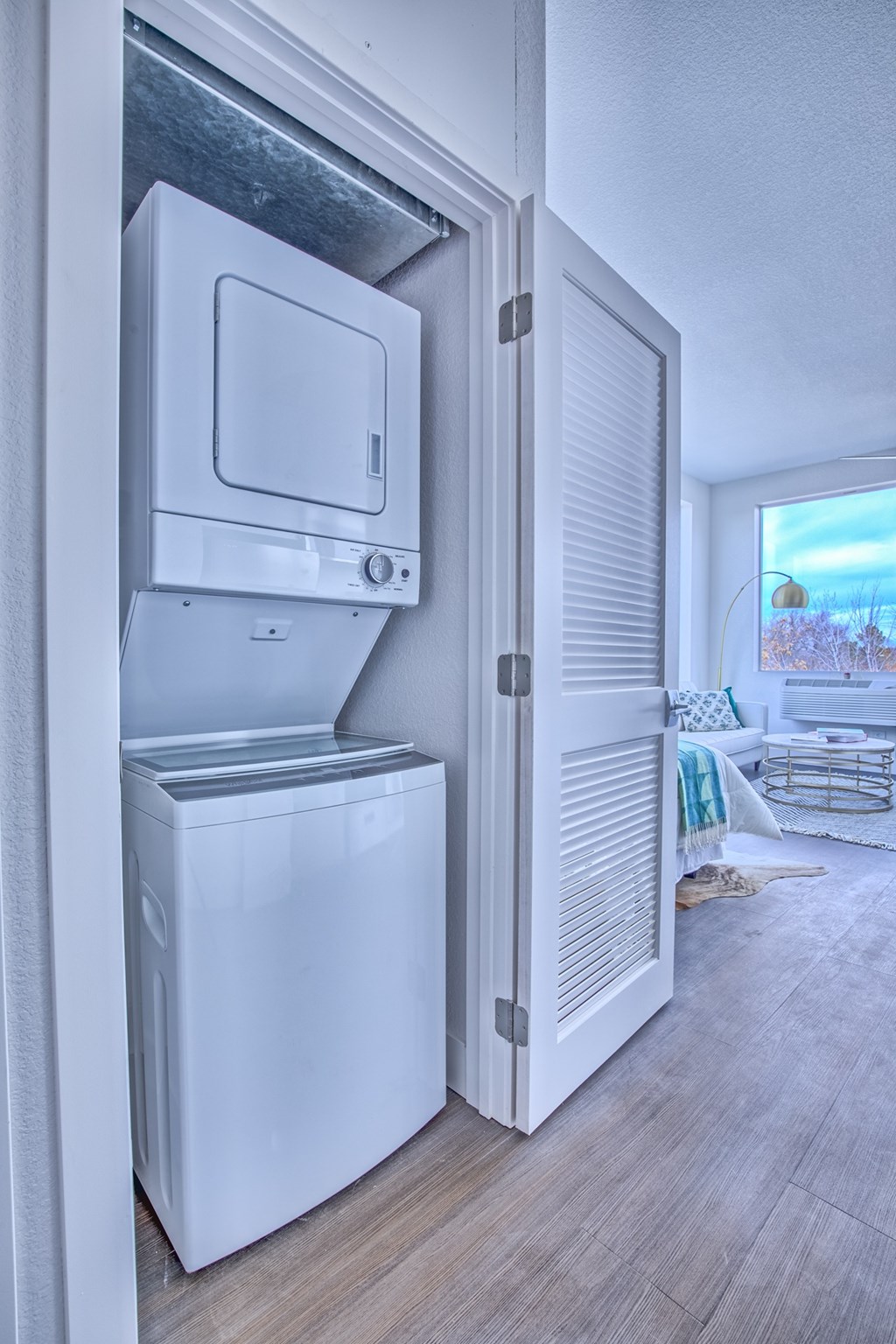 A white dryer and washer are installed in a wall.