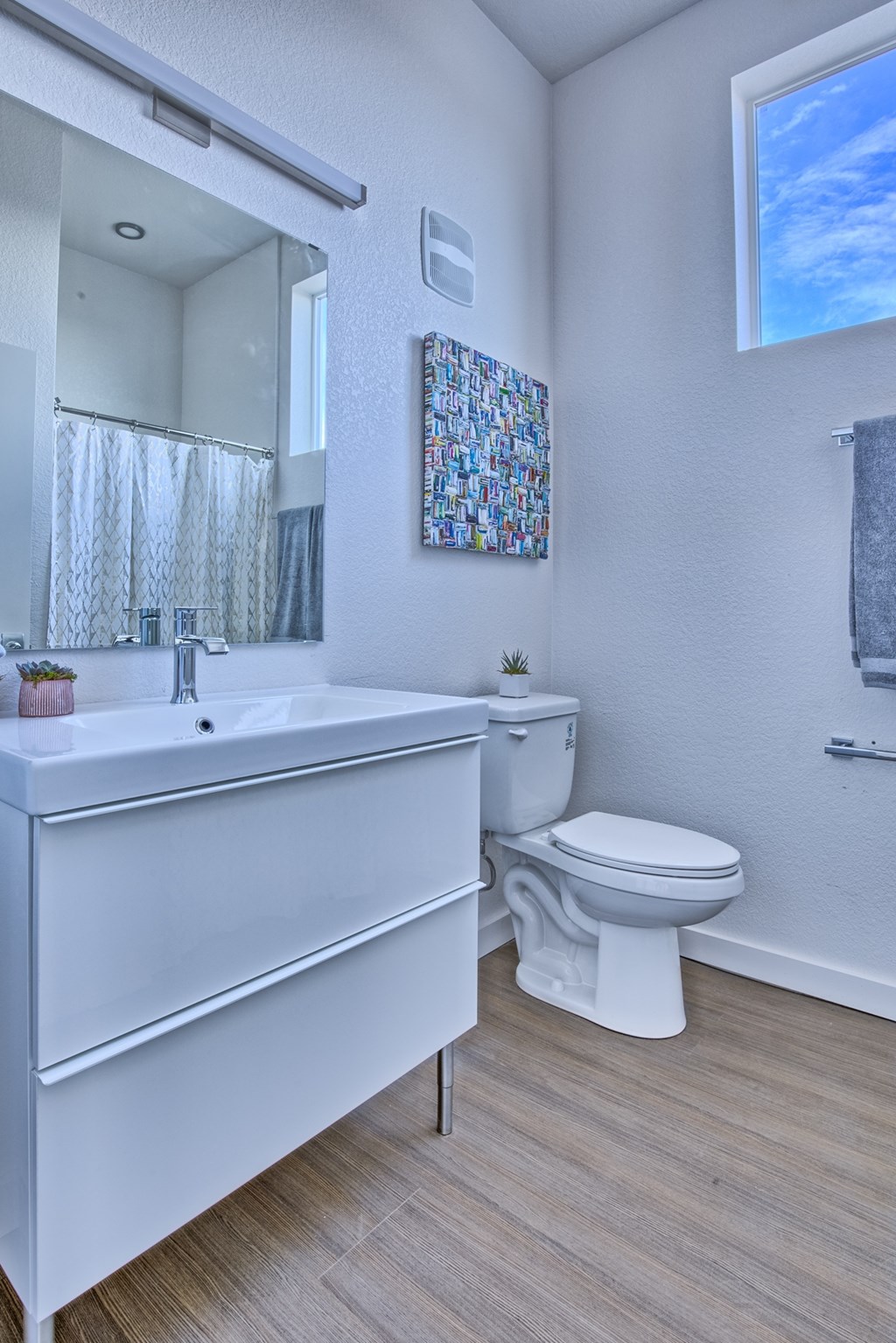 A white bathroom with a toilet and sink.