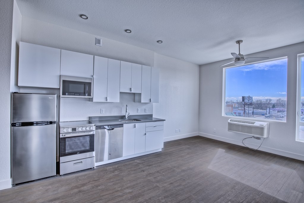 A modern kitchen with stainless steel appliances and white cabinets.