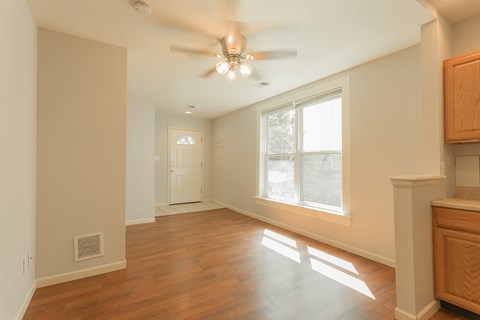 A room with a ceiling fan and a window.