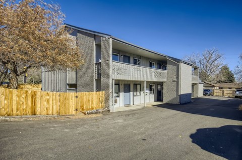 A modern building with a wooden fence in front.