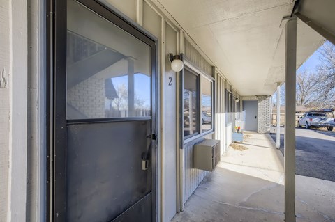 A view of a building's entrance with a glass door and a sign that reads "2".