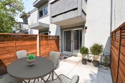 Private Patio with a table and chairs and a wooden fence