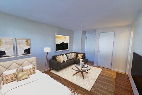 A bedroom with a large bed and a couch.