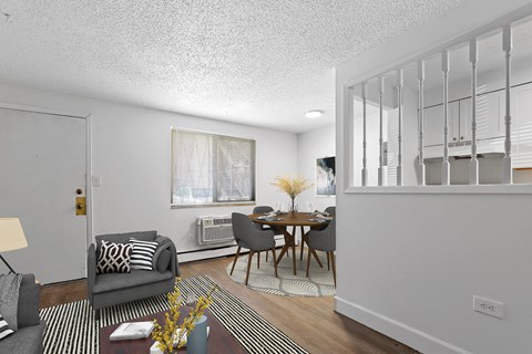 A living room with a grey couch and a wooden table.