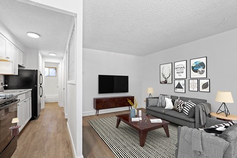 A living room with a grey couch and a coffee table.