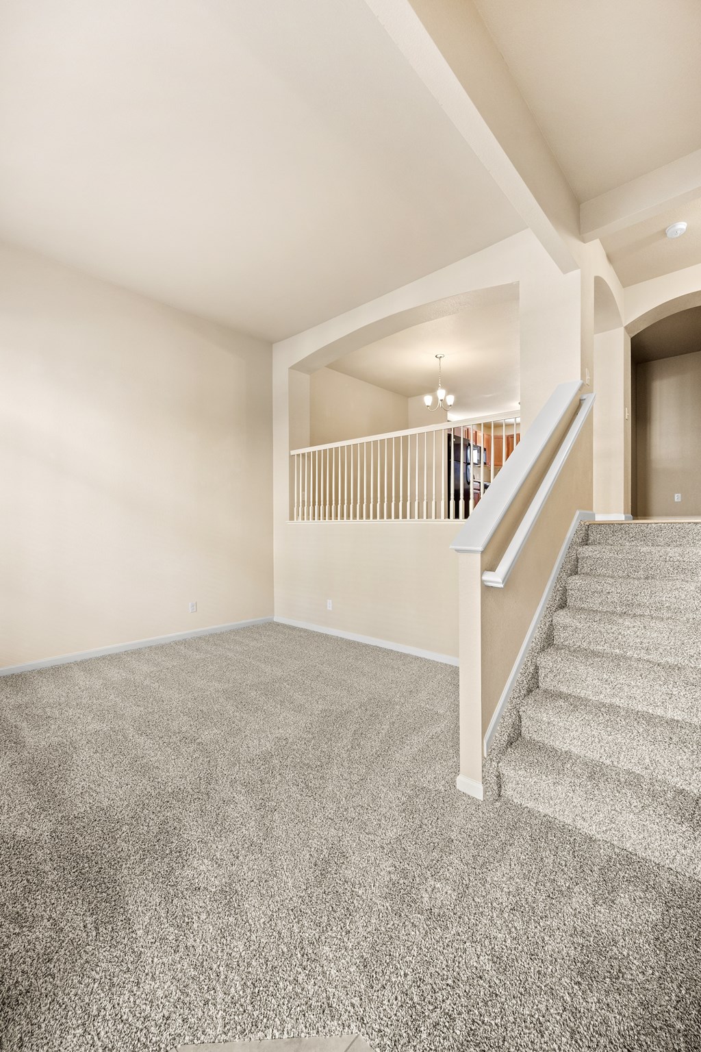 A staircase with a carpeted floor and a white railing.