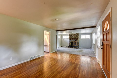 the living room and dining room of a house with wood floors