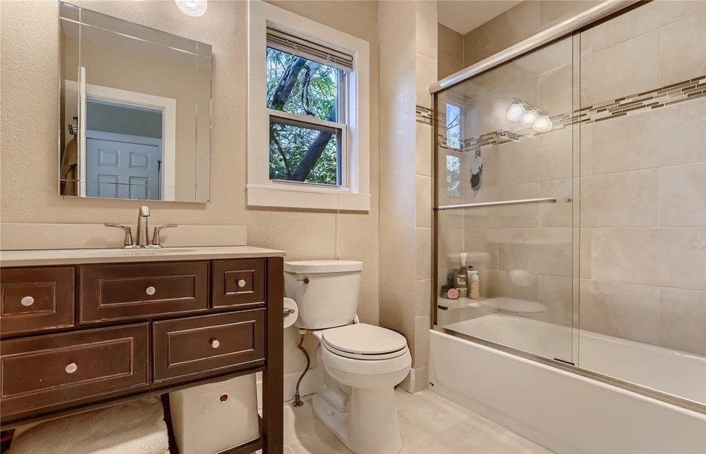 a bathroom with a shower toilet and sink