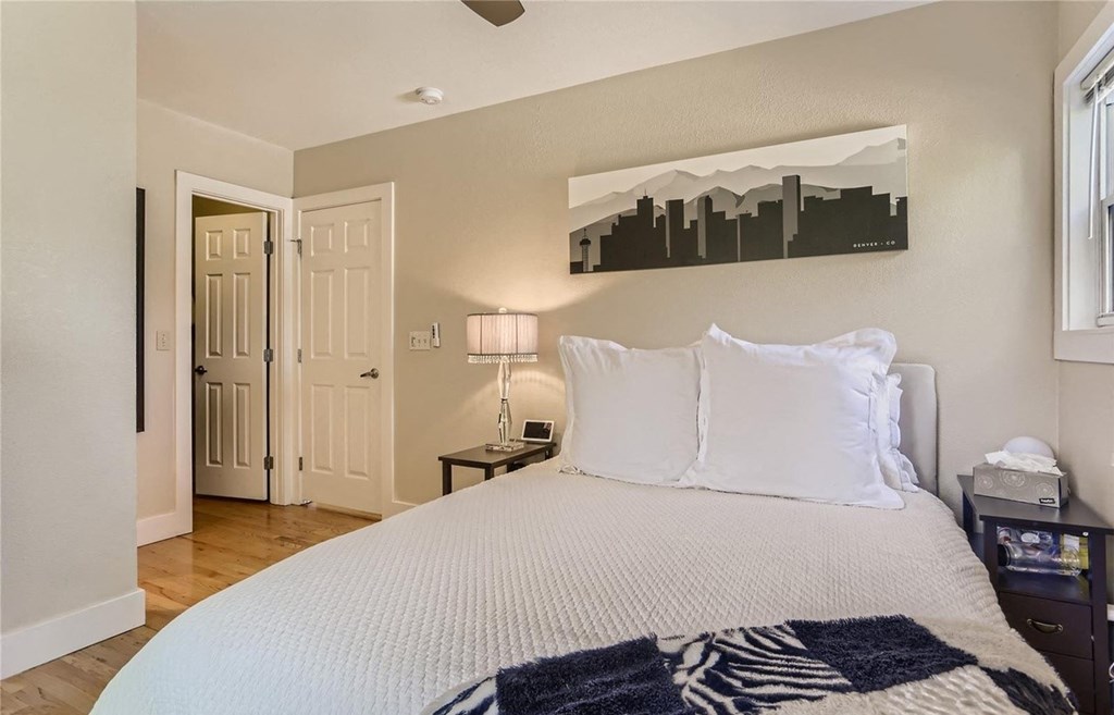 a bedroom with a large bed and a door to a bathroom