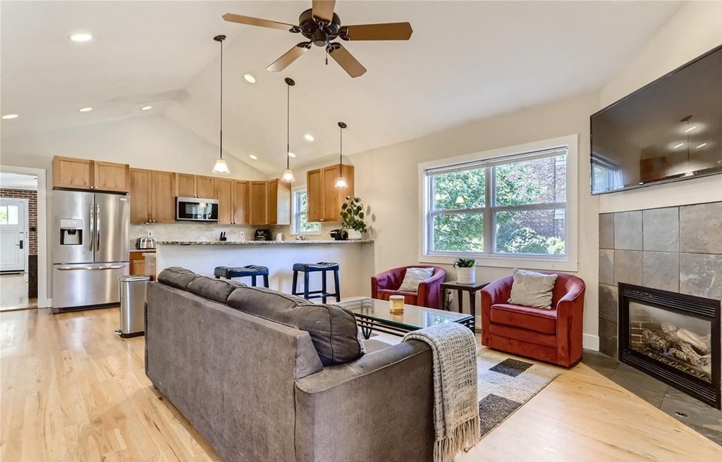 a living room with a couch in front of a fireplace