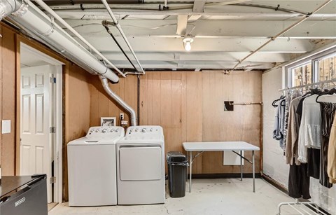 a laundry room with a washing machine and a table in it