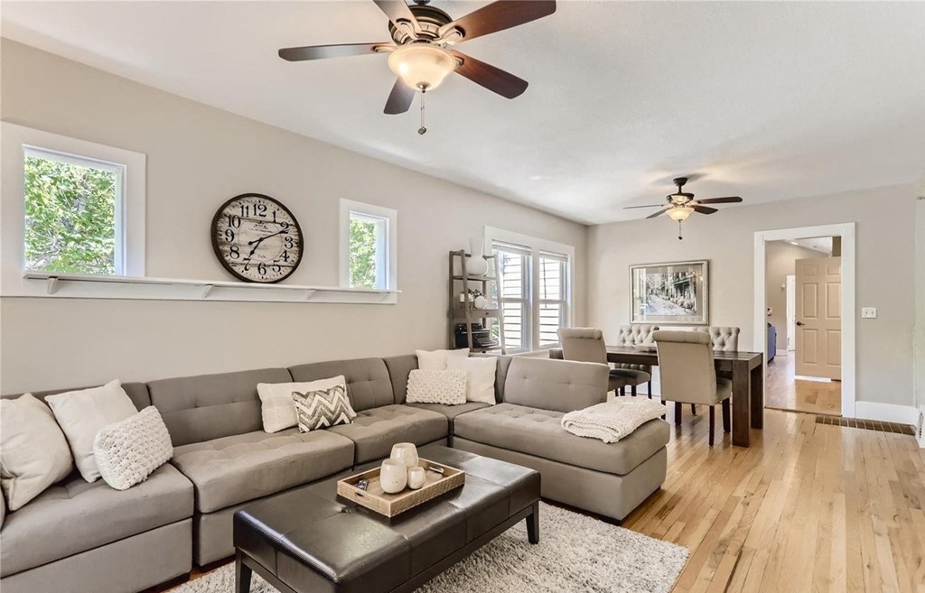 a living room with a couch and a ceiling fan