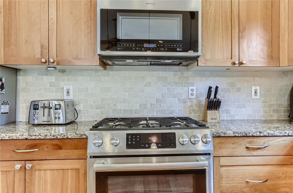 a kitchen with a stove and a microwave