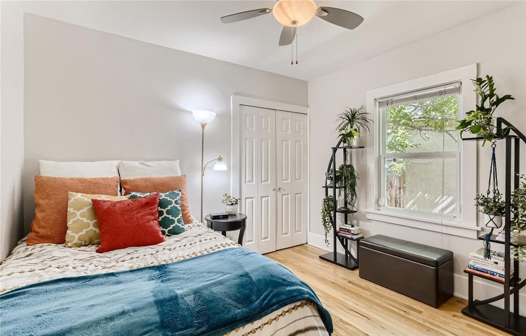 a bedroom with a bed and a ceiling fan