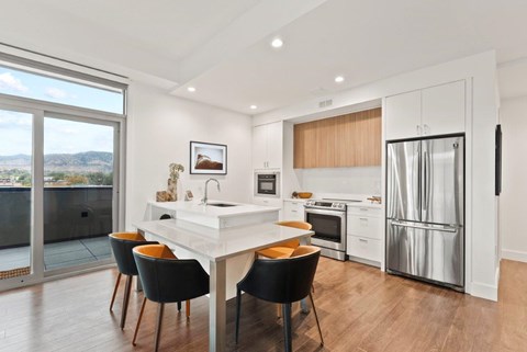 A modern kitchen with a dining table and chairs.
