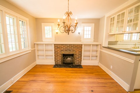 A living room with a fireplace and a chandelier.
