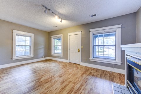 A room with wooden floors and a fireplace.