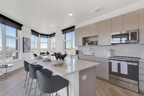an open kitchen and dining area with a table and chairs
