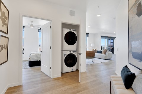 a living room with a washer and a dryer in a door